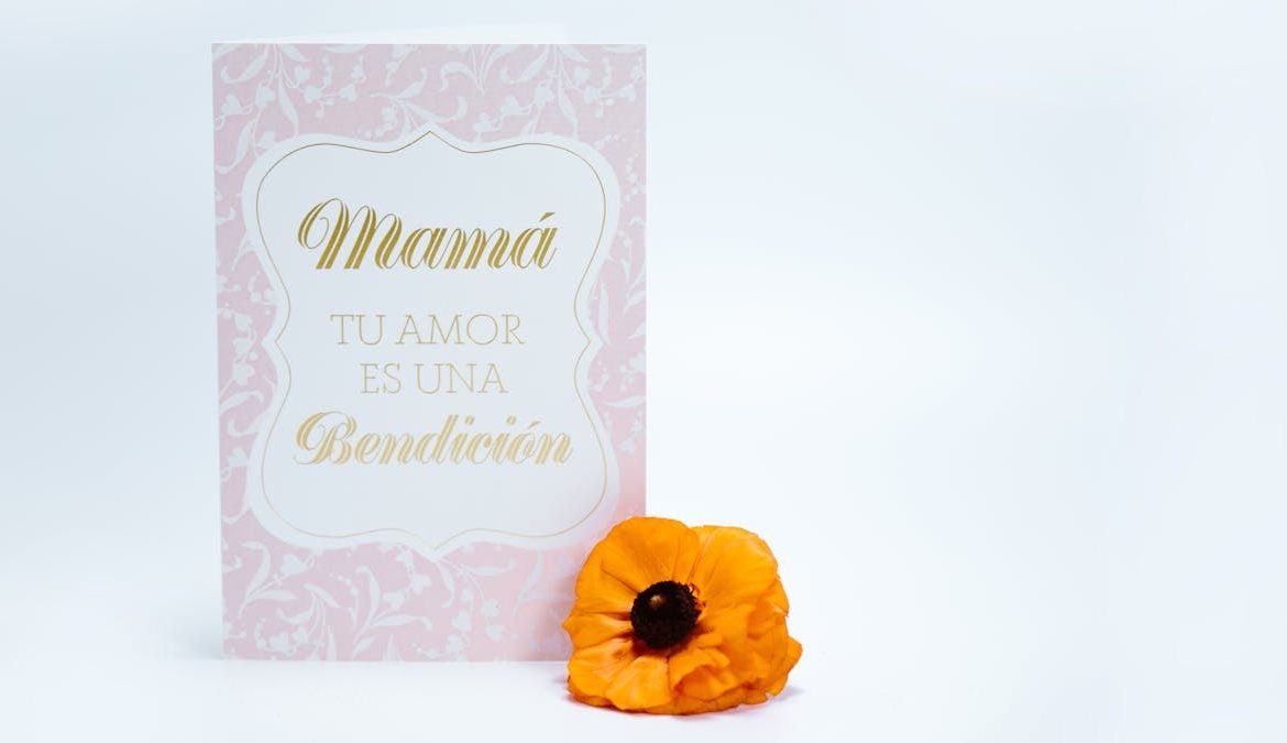 Chic Mother's Day card with 'Love is a blessing' text and a vibrant yellow flower.